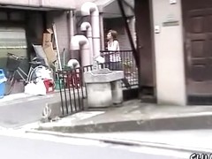 Japanese babe Street Sharking in front of a vending machine.