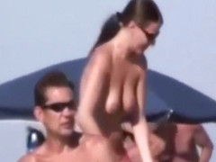 a couple masturbates on nudist beach