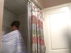 Voyeur tapes a hot brunette girl taking a shower