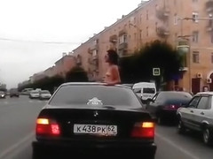 Topless babe riding in a BMW while in Russia