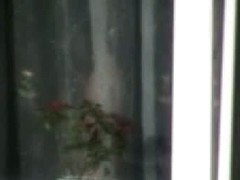 Naked mature woman caught from bedroom window by a voyeur