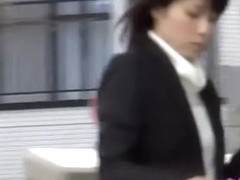 Japanese businesswoman loses a skirt during street sharking.