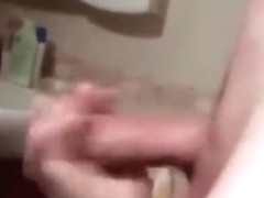 Cute brunette girl gives her bf a handjob in the bathroom, until he cums.