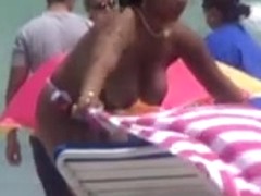 Plump breasted girl caught in a voyeur beach nudism video