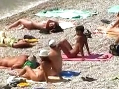 Muscular men and sleek women on a nude beach candid video