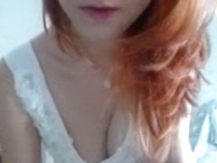 Redhead with big tits tries on clothes