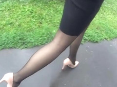 Following candid woman in black pantyhose and high heels