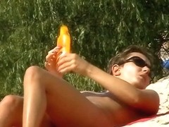 A luscious woman sunbathing in this nude beach voyeur video