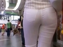 Beauty in tight white pants stars in a candid street video