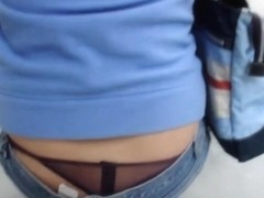 Sexy black string seen under blue jeans on candid street vid