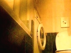 Hot and brunette taking a piss in her bathroom