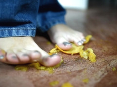 Pretty Brunette Crushing Oranges With Her Sexy Feet