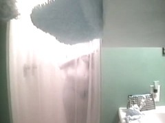 An alluring bimbo caught on a spy cam in the shower