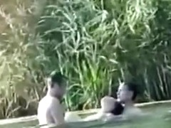 Voyeur tapes a slut having a threesome with 2 guys in the lake