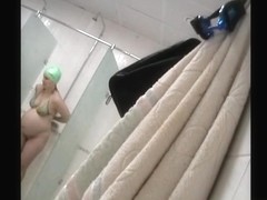 Pregnant woman with natural melons in the shower