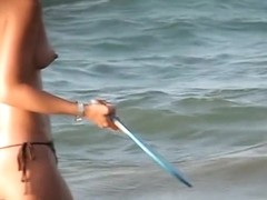 Voyeur films babes with naked tits playing on the beach