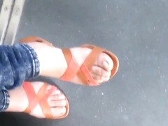 Teen with beautiful feet in the tramway