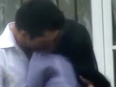 couple make out in front of the house