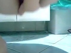 girl rides a flask of soap anally on the bathroom floor