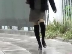 Asian babe gets a nasty skirt sharking on a rainy day.